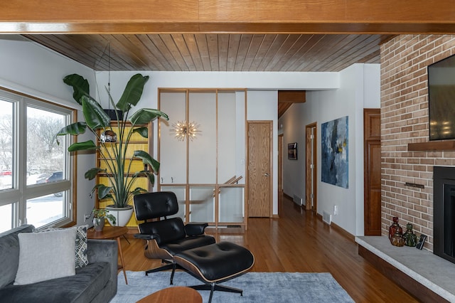 living room with visible vents, wooden ceiling, wood finished floors, vaulted ceiling with beams, and a fireplace