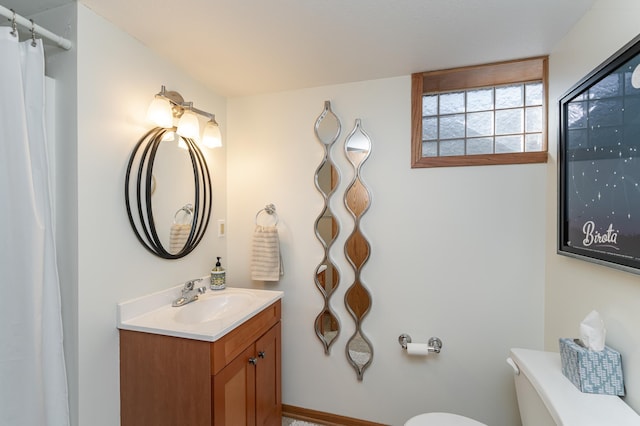 bathroom with toilet and vanity