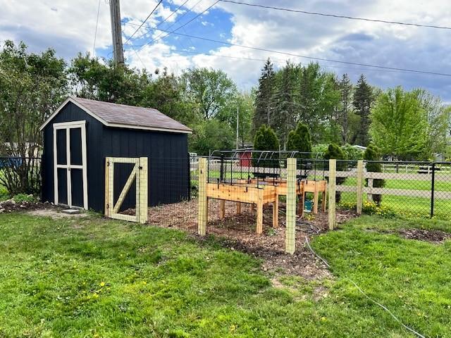 view of shed with fence