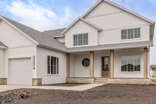 3254 Timber Creek Cir S, Fargo, ND 58104 - view of front of property with covered porch, stone siding, a shingled roof, a garage, and concrete driveway