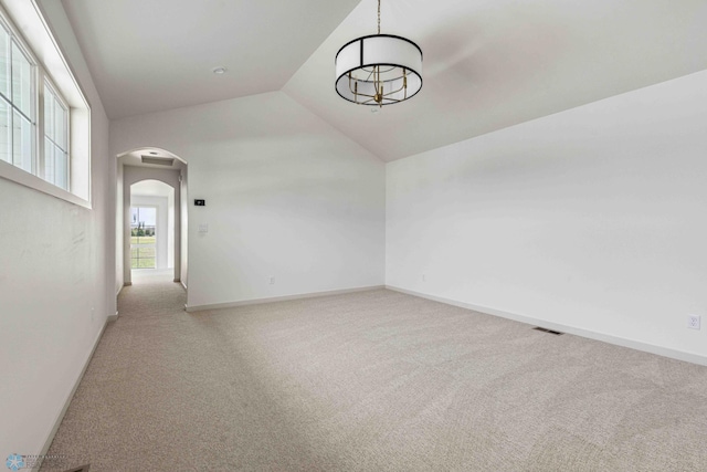 3254 Timber Creek Cir S, Fargo, ND 58104 - carpeted spare room with arched walkways, a chandelier, baseboards, and lofted ceiling