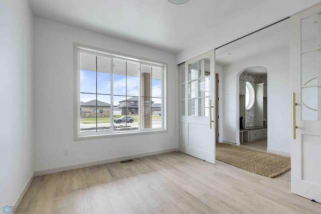 3254 Timber Creek Cir S, Fargo, ND 58104 - unfurnished room with arched walkways, wood finished floors, and baseboards
