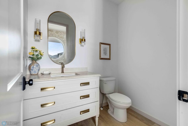 3254 Timber Creek Cir S, Fargo, ND 58104 - bathroom featuring wood finished floors, toilet, vanity, and baseboards