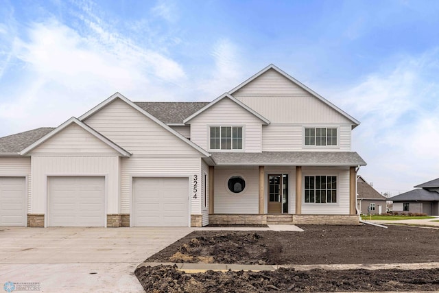 3254 Timber Creek Cir S, Fargo, ND 58104 - view of front of property featuring driveway, covered porch, a shingled roof, a garage, and stone siding