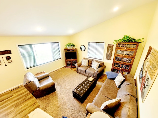 409 Hummingbird Ln, New York Mills, MN 56567 - living room featuring wood finished floors, a wealth of natural light, lofted ceiling, and visible vents