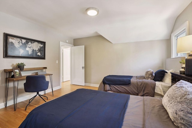 bedroom featuring light wood finished floors and baseboards