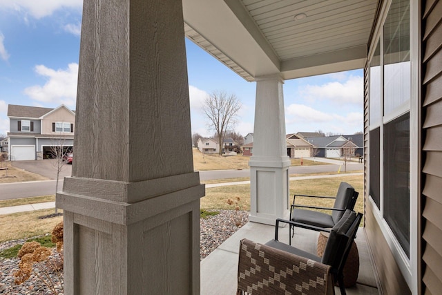 view of patio / terrace with a residential view and a porch