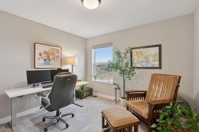 office area featuring light carpet and baseboards