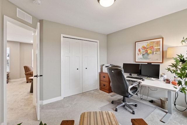office with visible vents, light colored carpet, and baseboards