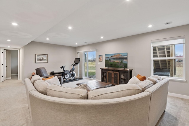 living room featuring baseboards, recessed lighting, and light carpet