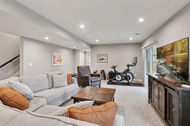 carpeted living area with baseboards, recessed lighting, and stairway