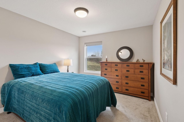 carpeted bedroom featuring baseboards