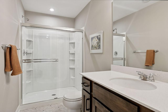full bathroom with a shower stall, vanity, recessed lighting, and toilet
