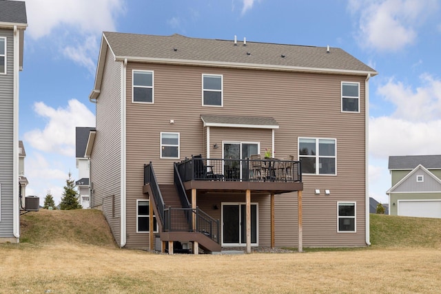 rear view of house featuring central AC, a lawn, a wooden deck, and stairs