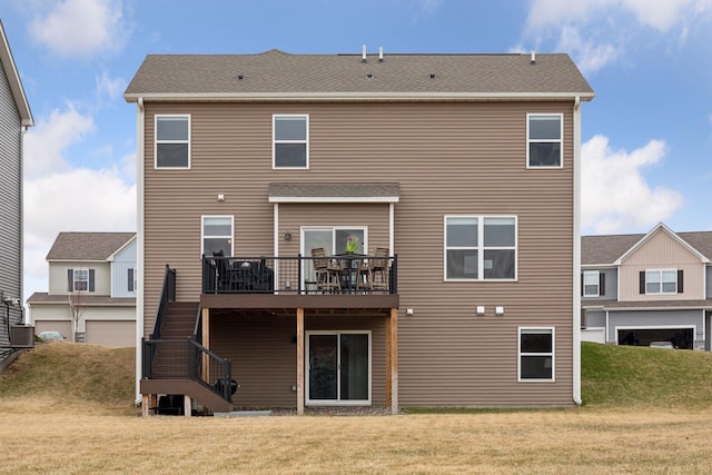 rear view of property with central AC unit, stairs, a deck, and a lawn