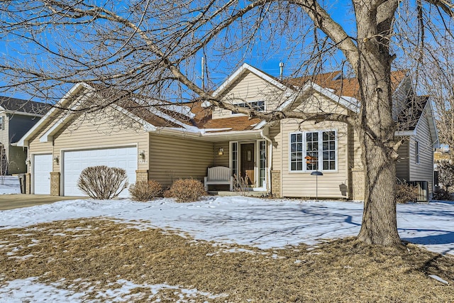 view of front of home featuring a garage and brick siding