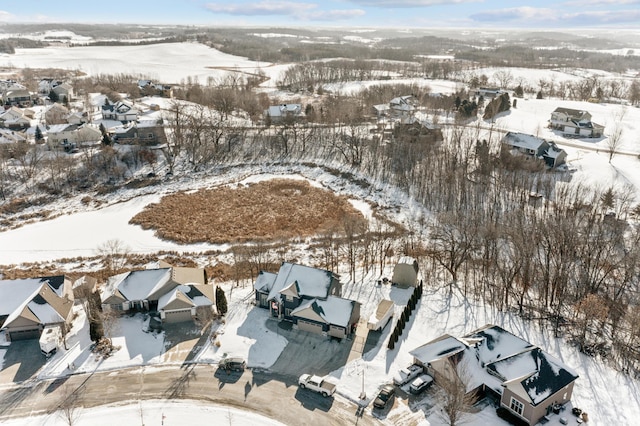 snowy aerial view with a residential view