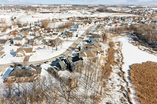 snowy aerial view with a residential view