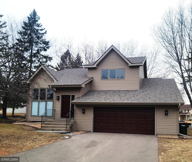 view of front of property featuring a garage, aphalt driveway, and roof with shingles