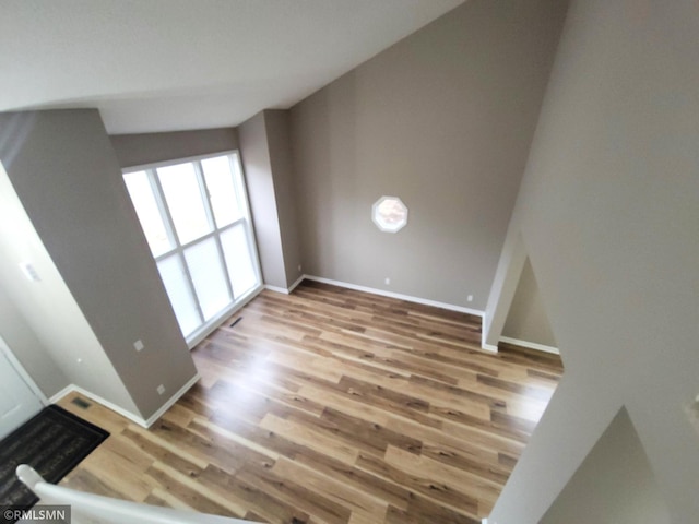 interior space featuring baseboards and wood finished floors