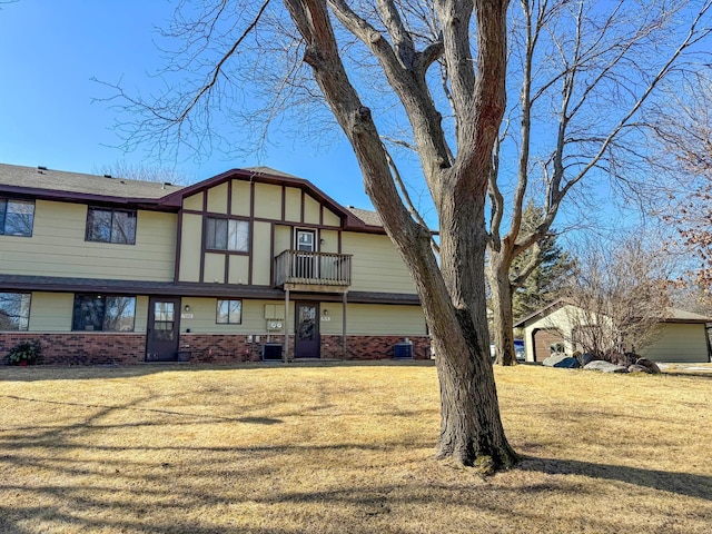 back of property with central air condition unit and a lawn