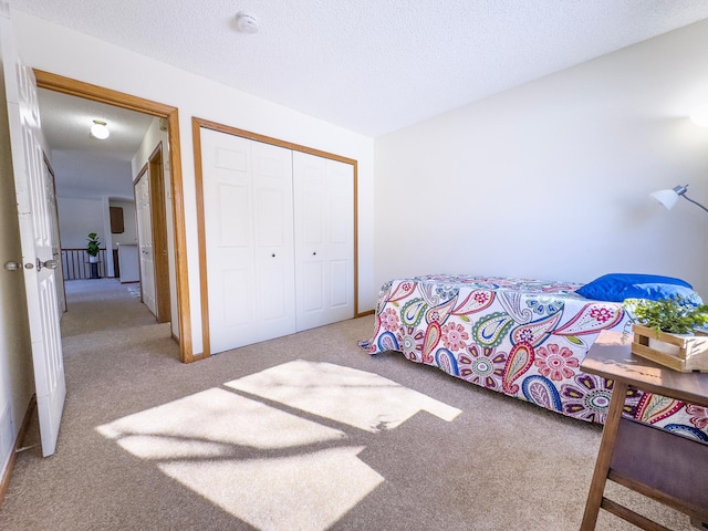 carpeted bedroom featuring a closet and a textured ceiling