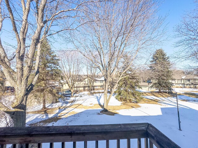 snowy yard featuring a residential view