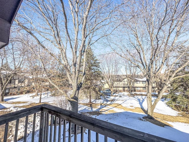 snow covered deck with a residential view