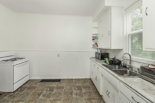 kitchen featuring light countertops, white cabinetry, white gas stove, and open shelves