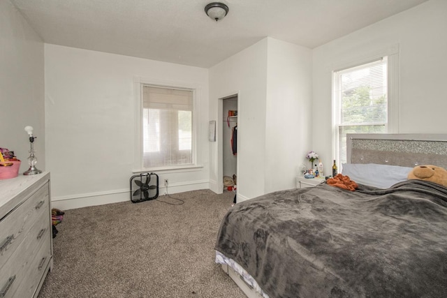 carpeted bedroom featuring baseboards