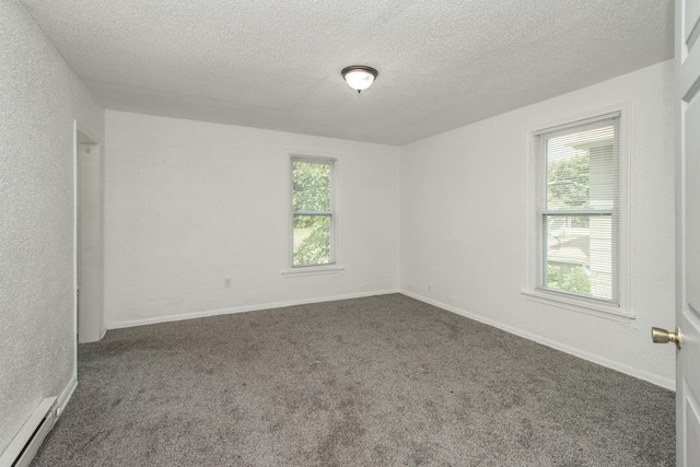 unfurnished room featuring a baseboard radiator, baseboards, dark colored carpet, and a textured ceiling