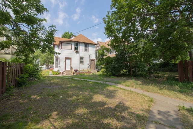 view of front of property featuring entry steps and fence