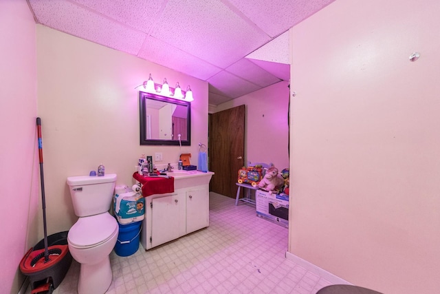 playroom featuring light floors, a sink, and a paneled ceiling