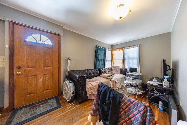 interior space with ornamental molding and wood finished floors