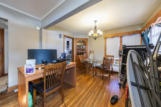 office space with crown molding, baseboards, wood finished floors, and a notable chandelier