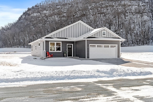 view of front of home featuring board and batten siding, driveway, and an attached garage