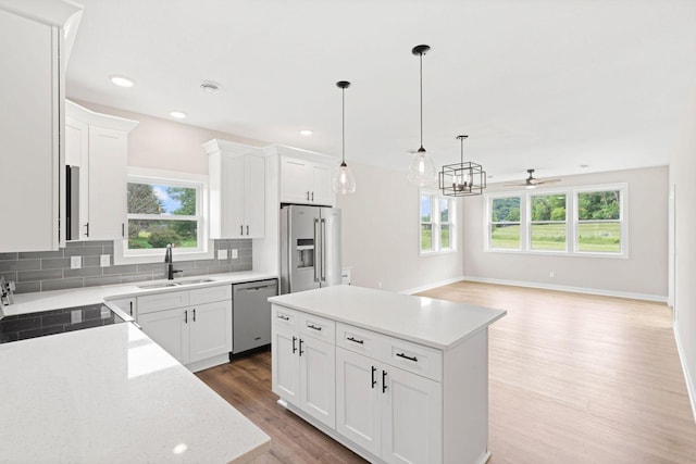 585 Cedar Dr, Lake City, MN 55041 - kitchen featuring appliances with stainless steel finishes, plenty of natural light, light wood-style floors, backsplash, and recessed lighting