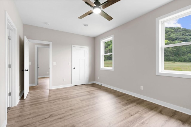 585 Cedar Dr, Lake City, MN 55041 - unfurnished bedroom featuring light wood finished floors and ceiling fan