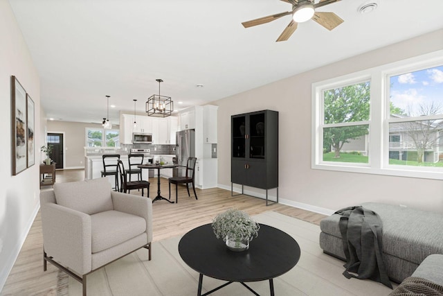 585 Cedar Dr, Lake City, MN 55041 - living area featuring a ceiling fan, light wood-style floors, recessed lighting, and a chandelier