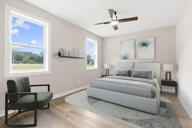 585 Cedar Dr, Lake City, MN 55041 - bedroom featuring multiple windows, wood finished floors, and ceiling fan