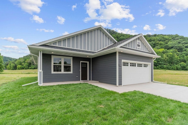 585 Cedar Dr, Lake City, MN 55041 - view of front of house with a garage, board and batten siding, and a front yard