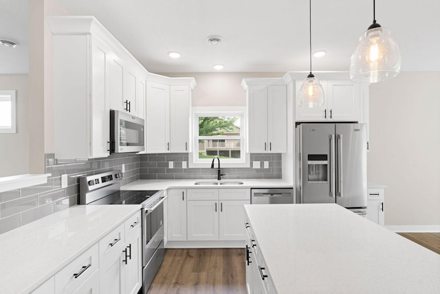 585 Cedar Dr, Lake City, MN 55041 - kitchen with stainless steel appliances, plenty of natural light, decorative backsplash, and recessed lighting