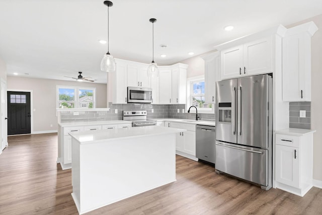 585 Cedar Dr, Lake City, MN 55041 - kitchen featuring appliances with stainless steel finishes, decorative backsplash, light countertops, wood finished floors, and recessed lighting