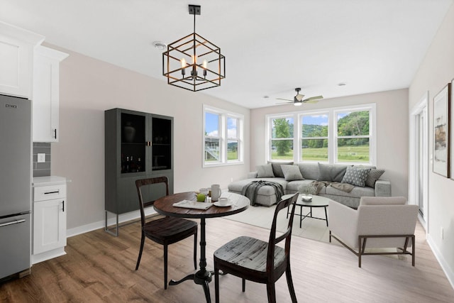 585 Cedar Dr, Lake City, MN 55041 - dining room featuring wood finished floors, ceiling fan, and a chandelier