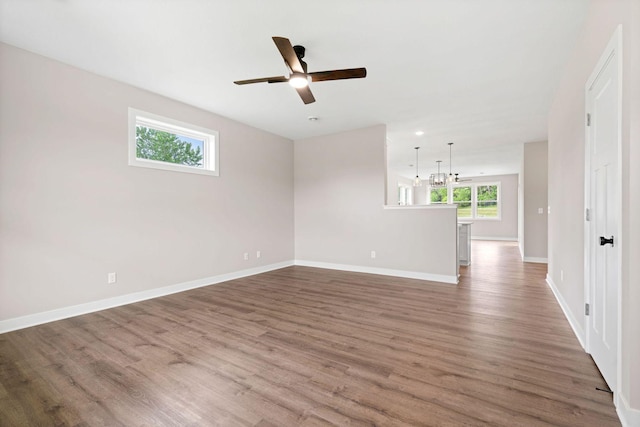 585 Cedar Dr, Lake City, MN 55041 - spare room with ceiling fan, wood finished floors, and a chandelier