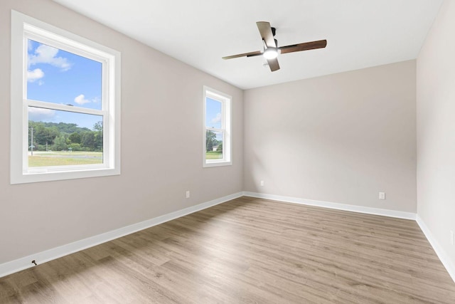 585 Cedar Dr, Lake City, MN 55041 - empty room featuring plenty of natural light, light wood-style floors, and a ceiling fan