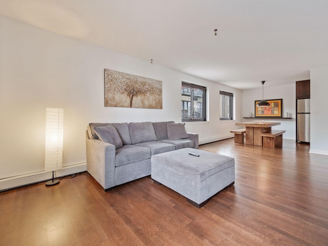 living room featuring dark wood-style floors, baseboards, and baseboard heating