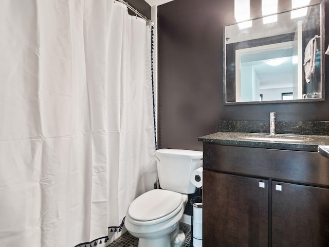 bathroom with toilet, tile patterned floors, and vanity