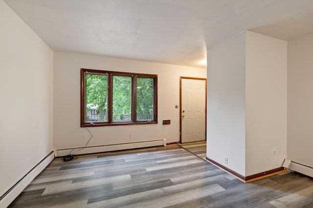 1022-1024 34th Ave N, Minneapolis, MN 55412 - empty room featuring baseboard heating, light wood-style flooring, and baseboards