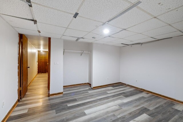 1022-1024 34th Ave N, Minneapolis, MN 55412 - unfurnished bedroom with wood finished floors, baseboards, a closet, and a paneled ceiling